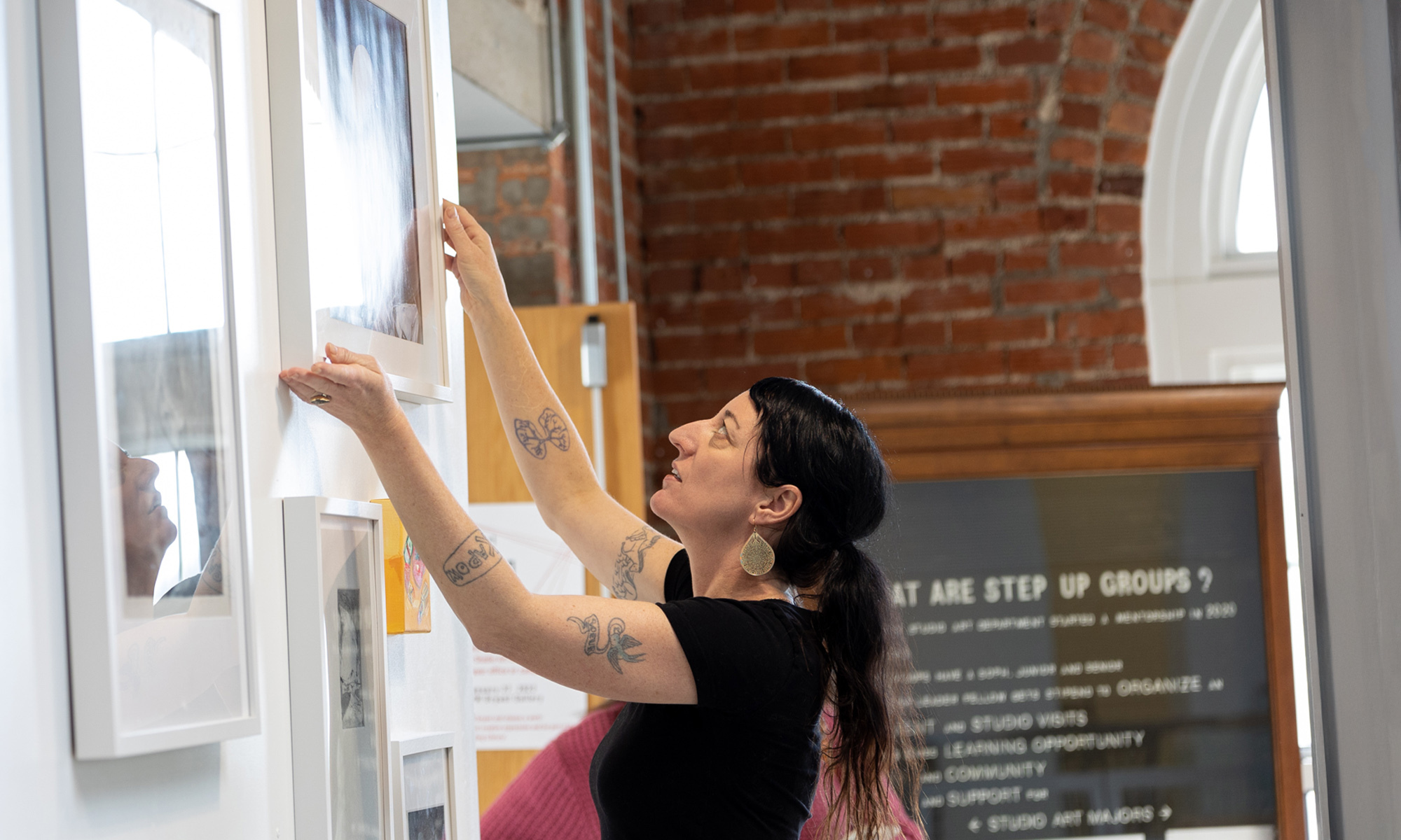 An artist installing an exhibit