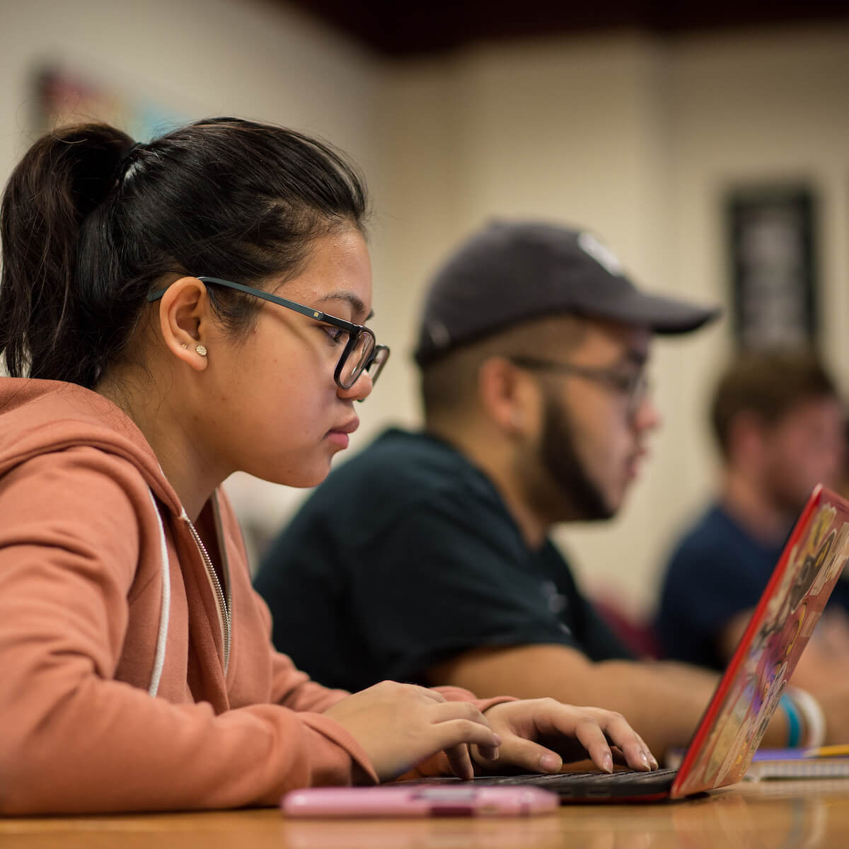 Students work on laptops.