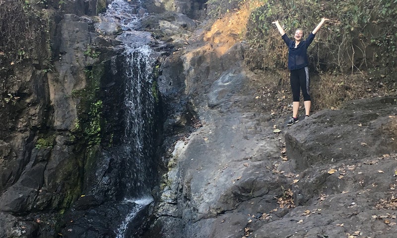 Bailey Greene '18 by waterfall in Cuba