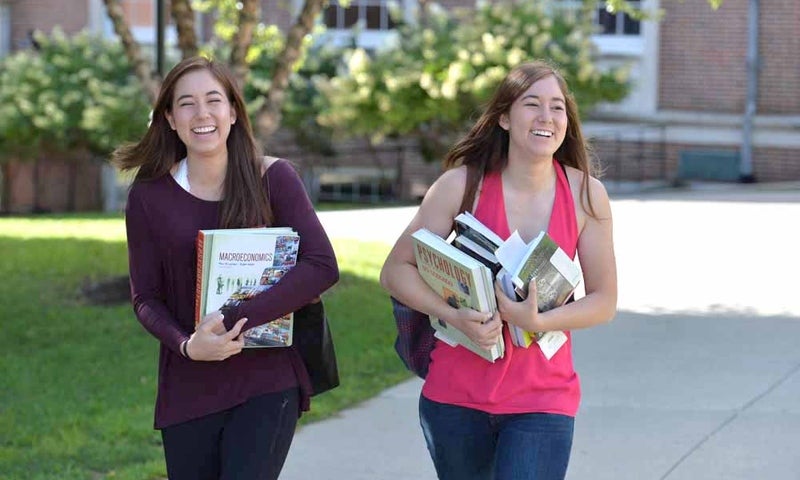 two Denison students walking on the quad during the start of the fall 2016 semester