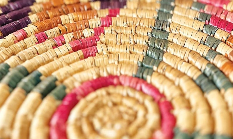 Close up image of material woven into a circular pattern; image taken from cover of "Pedagogies of Interconnectedness: Feminist-Queer Collaborative Transformation"