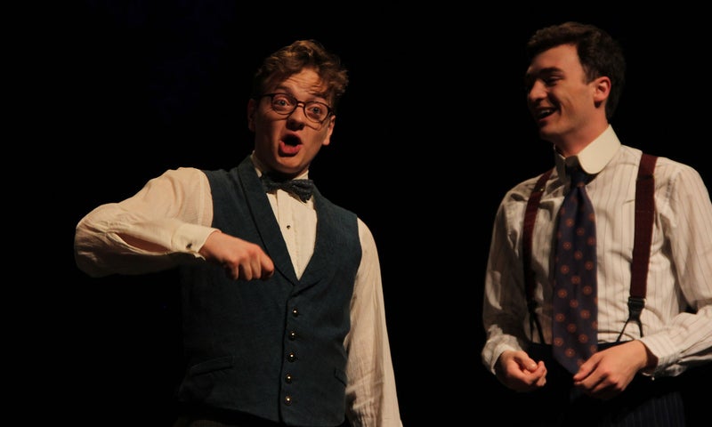 Two ensemble members, performing as students Clifford Richard and Homer Hollis, excitedly give a presentation for the Chemical Society in 1911