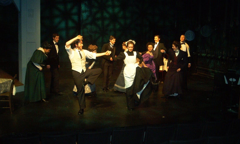 The maid, Lilly, and Freddy Malins energetically dance together as the rest of the party joins in.