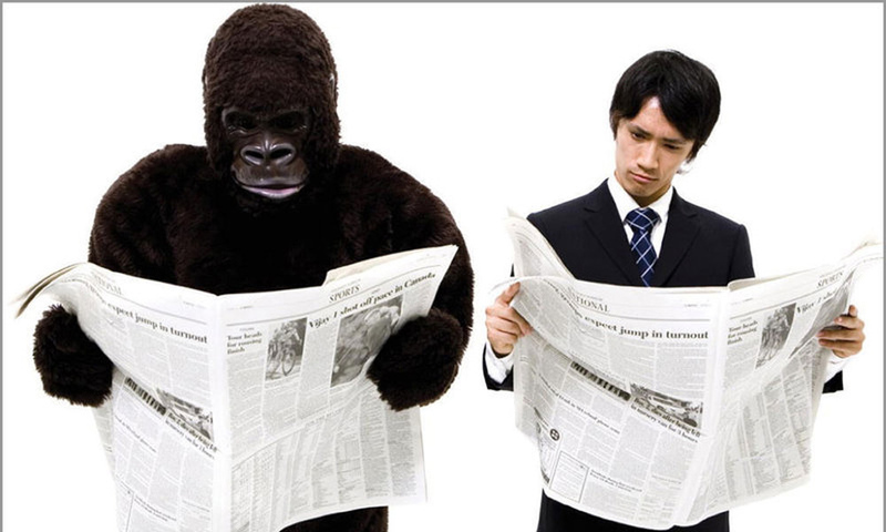 Gorilla and man reading newspapers