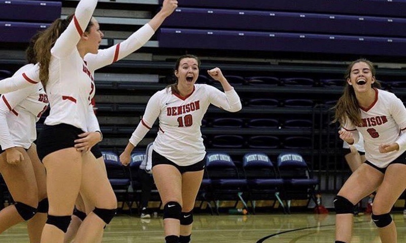 Julia Miller and teammates celebrate during a volleyball match