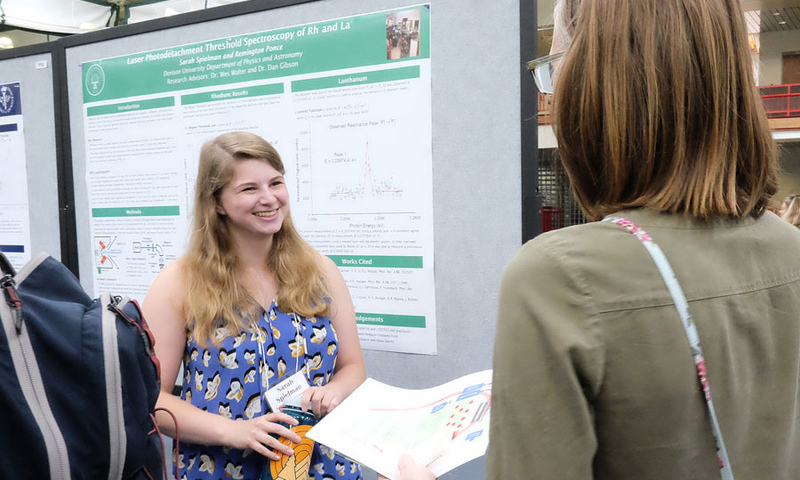 Student presenting her research to woman