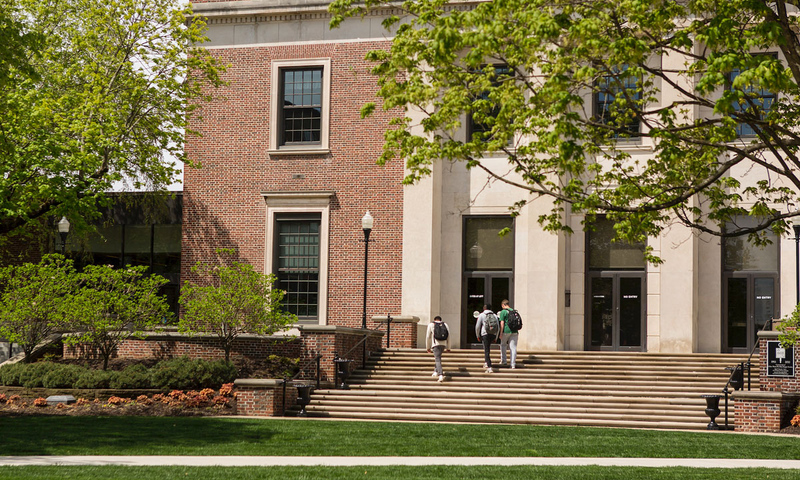 Students walking up steps to library