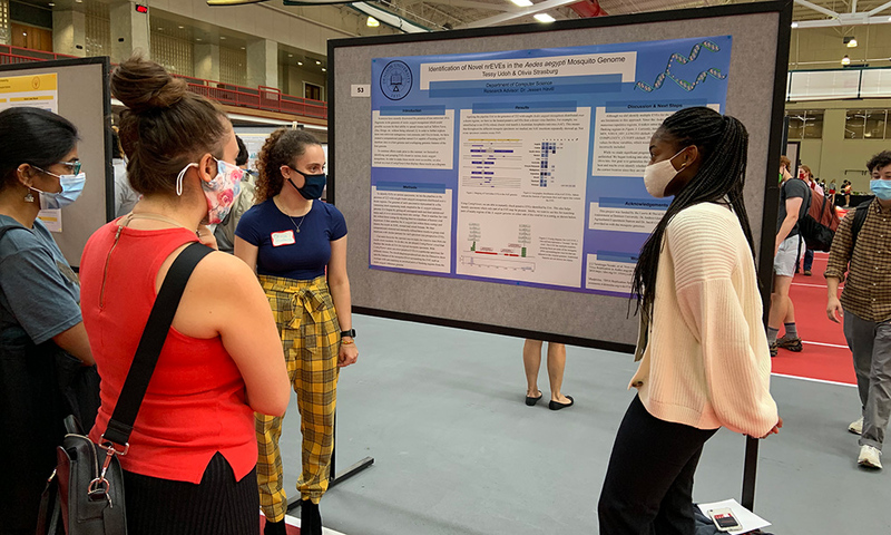 Students presenting their summer research poster