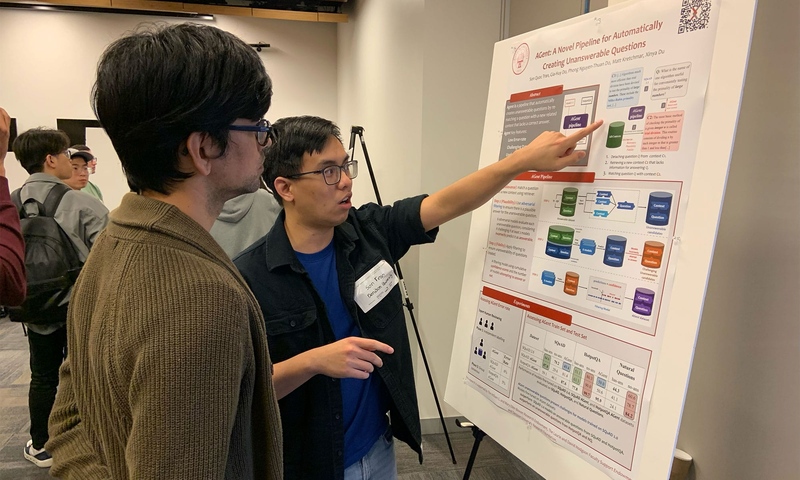 Son Tran presenting a poster board at a conference in Los Angeles