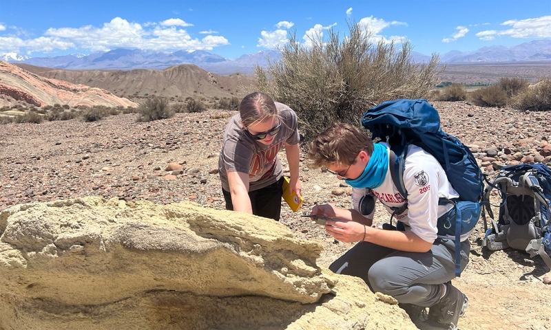 Students observing a rock