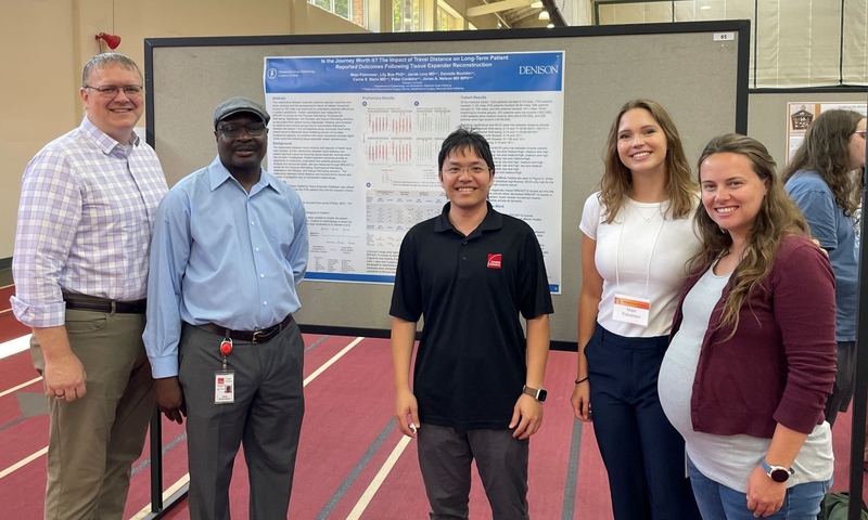Owens Corning representatives with Denison applied math and data analytics double major Maja Palmroos at Knowlton Center Summer Scholars Symposium in the Mitchell Center