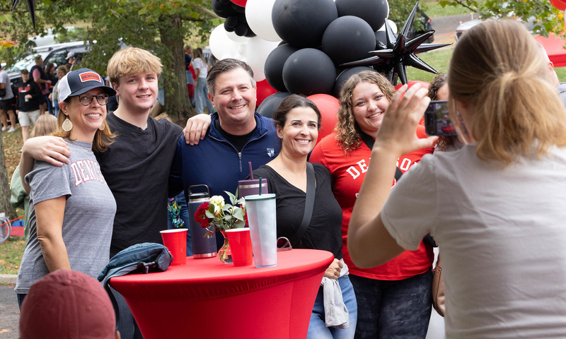 Alumni at Big Red Weekend post for a photo.