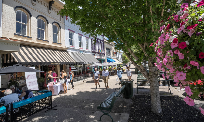 Photo of Granville street lined with restaurants, shops, and people on a spring day.