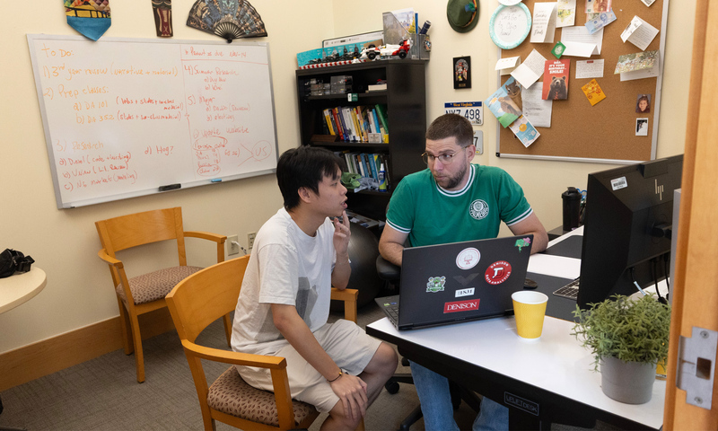 Duy Anh Nguyen ’27 and Alexandre Scarcioffolo meeting in a faculty office.