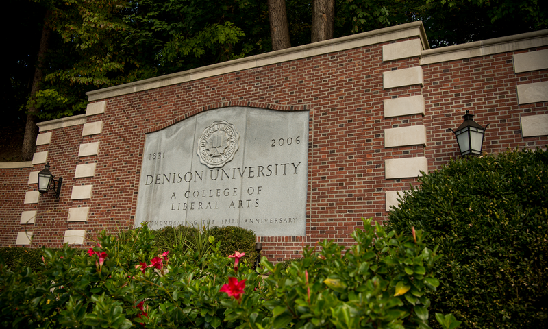 Presidents' Drive sign at the entrance to campus reads "Denison University."