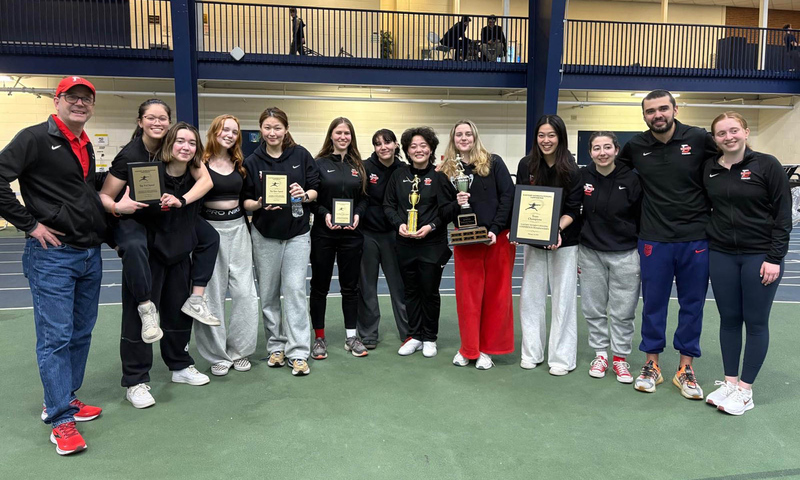 Denison fencers and coaches pose for a group photo celebrating their Eastern Women's Fencing Conference win.