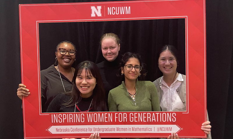 Photo of five Denison students attending the Nebraska Conference for Undergraduate Women in Mathematics (NCUWM) in late January 2025.
