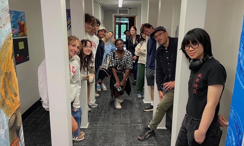 Visual Arts students with Professor Keith Spencer in the Denison Libraries' throughway and location of their spring 2025 class exhibition.