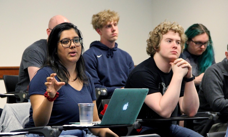 Students sitting in a classroom lecture listening to a seminar speaker..