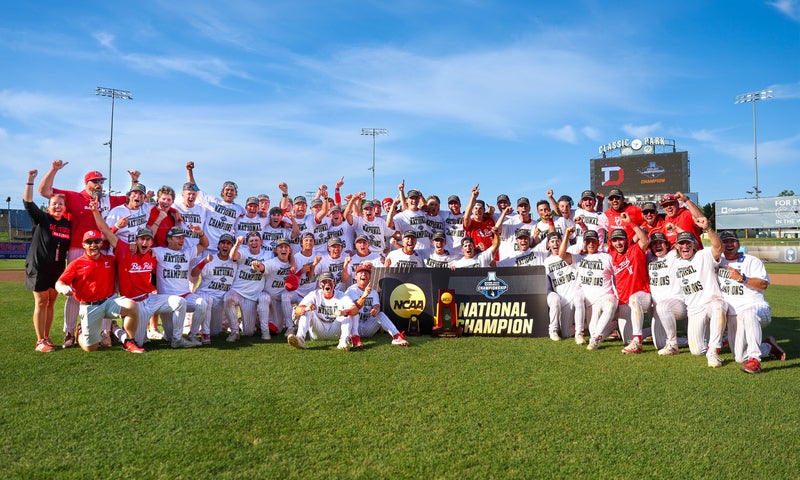 The Denison baseball team poses for a photo with their national championship trophy.