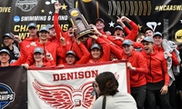 Denison men's swimming and diving team celebrates championship holding NCAA trophy.