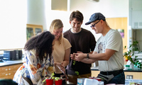 Photo of Hauk speaking with some of his teaching assistants
