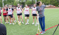 A group of players from Denison Women's Lacrosse at practice with coach Amanda Daniels.
