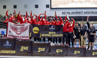 The Denison swimming and diving team celebrates on the podium poolside after winning the national championship.