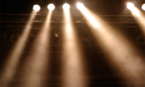 Photo of stage lights against a dark background 
