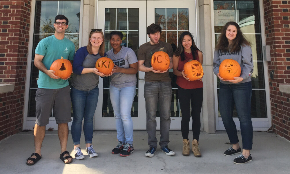 students with carved pumpkins