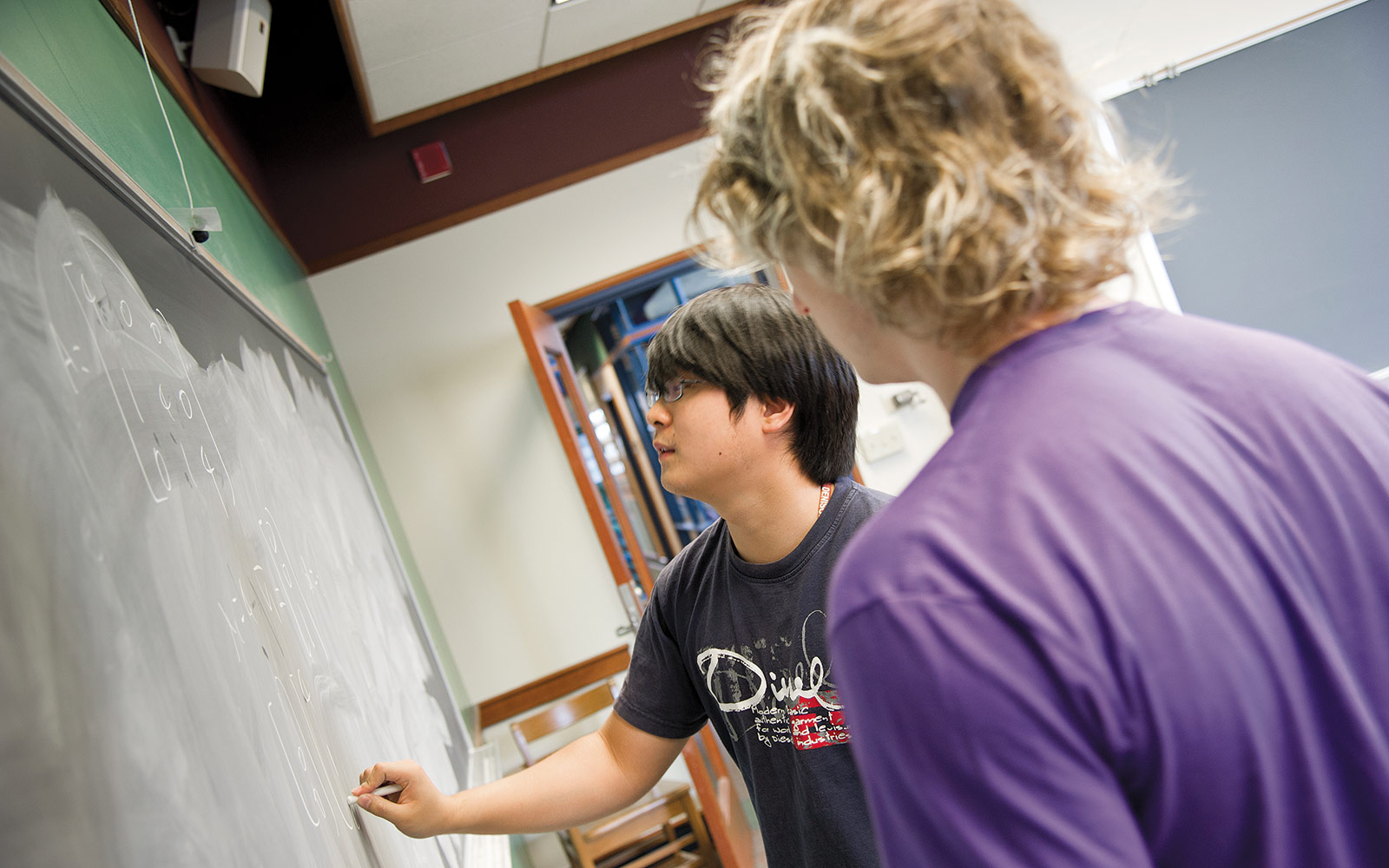 I found these guys working on a huge math equation during their lunch break. They said they just do this for fun. I looked at the equation, and of course it meant absolutely nothing to me. It was almost the length of the blackboard. I found these guys working on a huge math equation during their lunch break. They said they just do this for fun. I looked at the equation, and of course it meant absolutely nothing to me. It was almost the length of the blackboard.