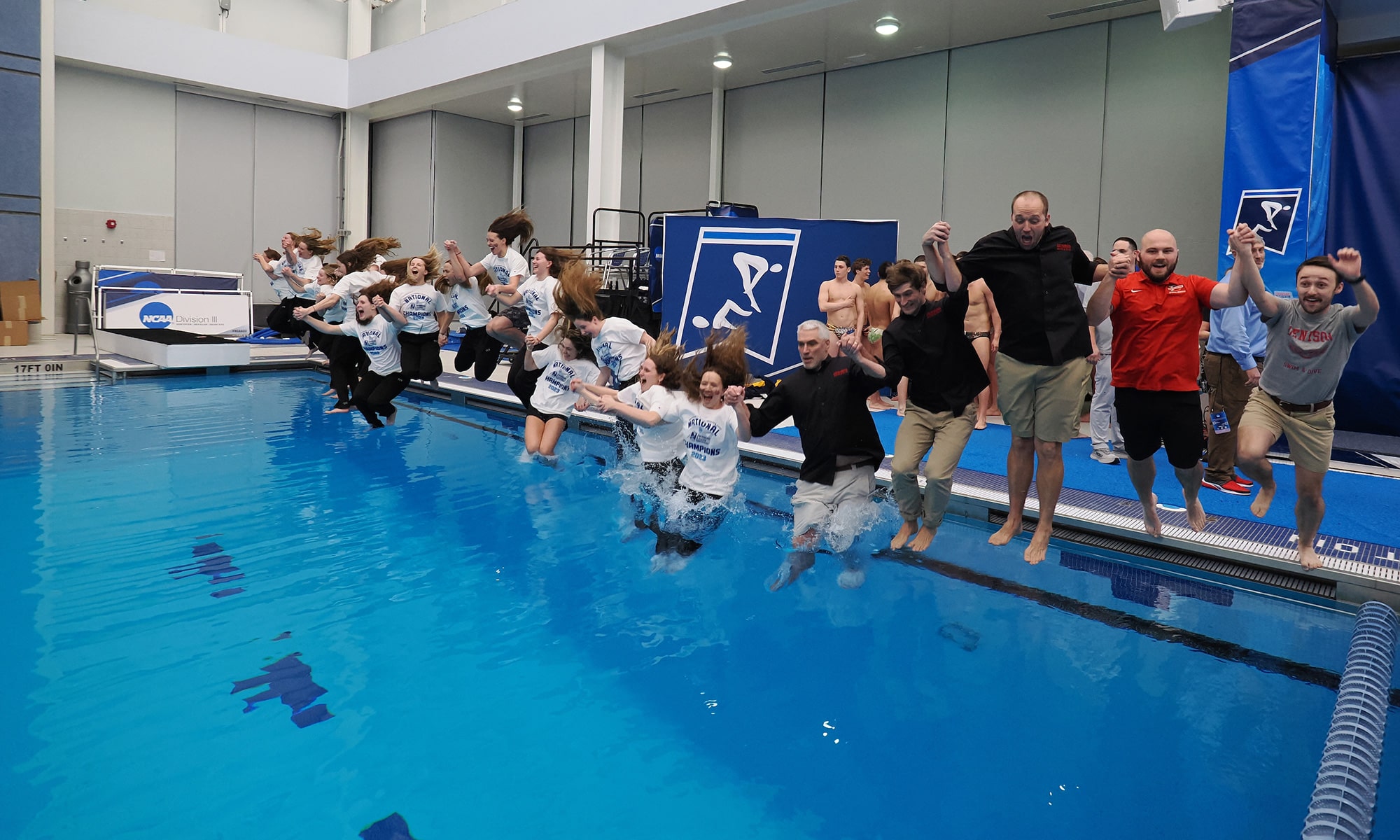 The Denison swim team jumps into the pool together