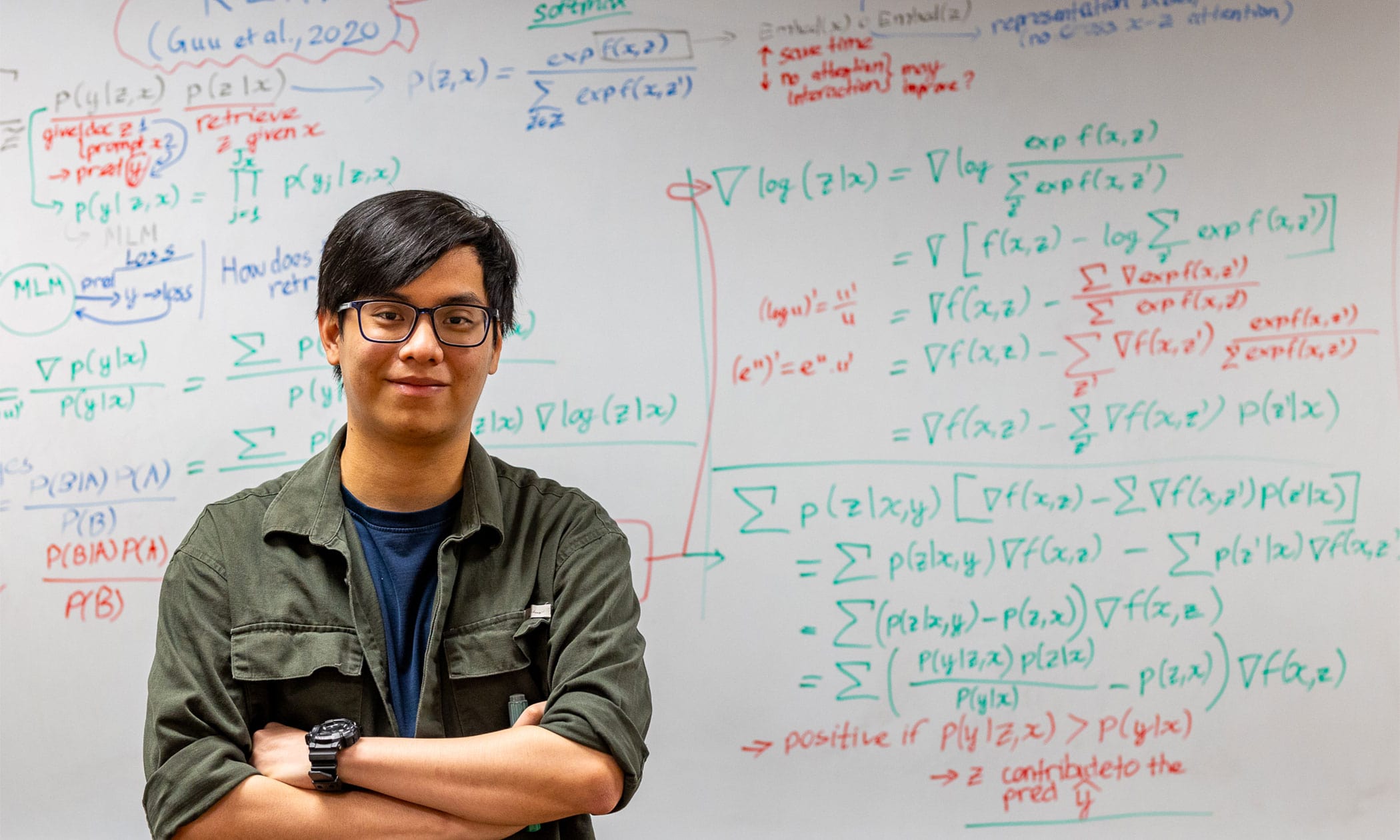 Son in front of a whiteboard with math all over it