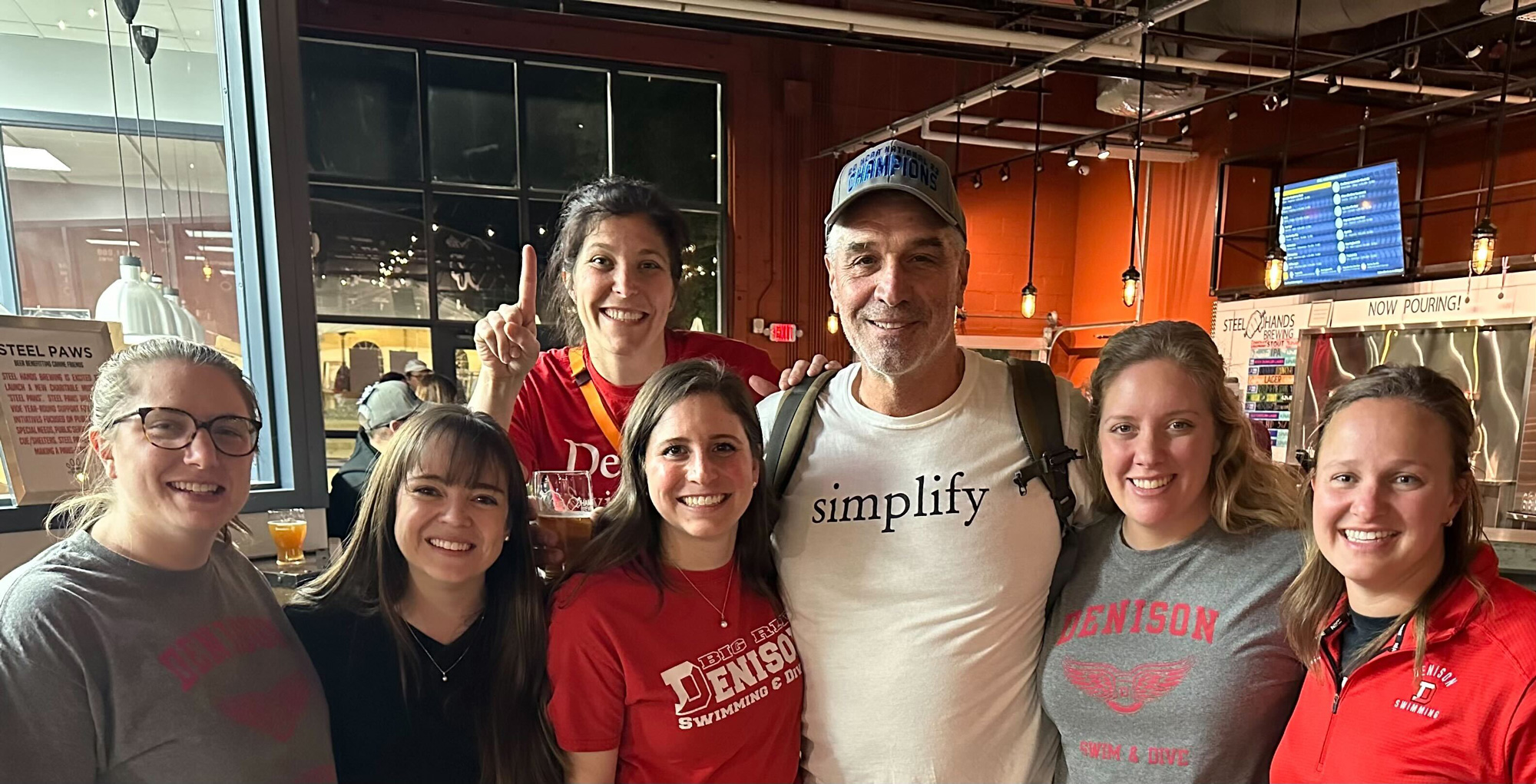A group photo of Brenna Broadus, Michelle Howell Simonelli, Mollie Parrish Zook, Alyssa Swanson, coach Gregg Parini, Hilary Callen, Emily Schroeder.