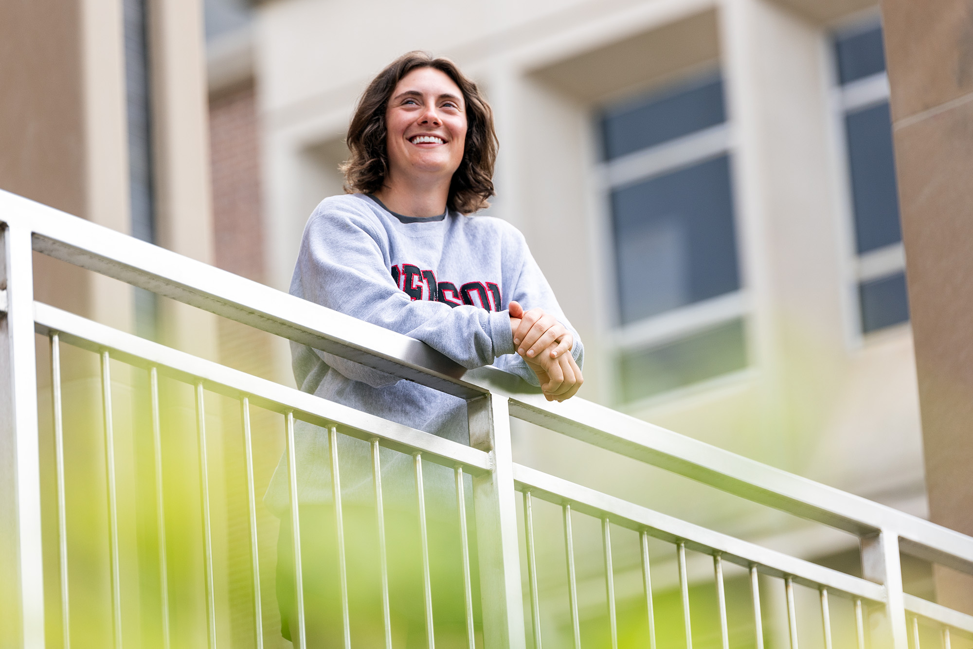 Kate Griffin standing behind a railing and looking into the distance.