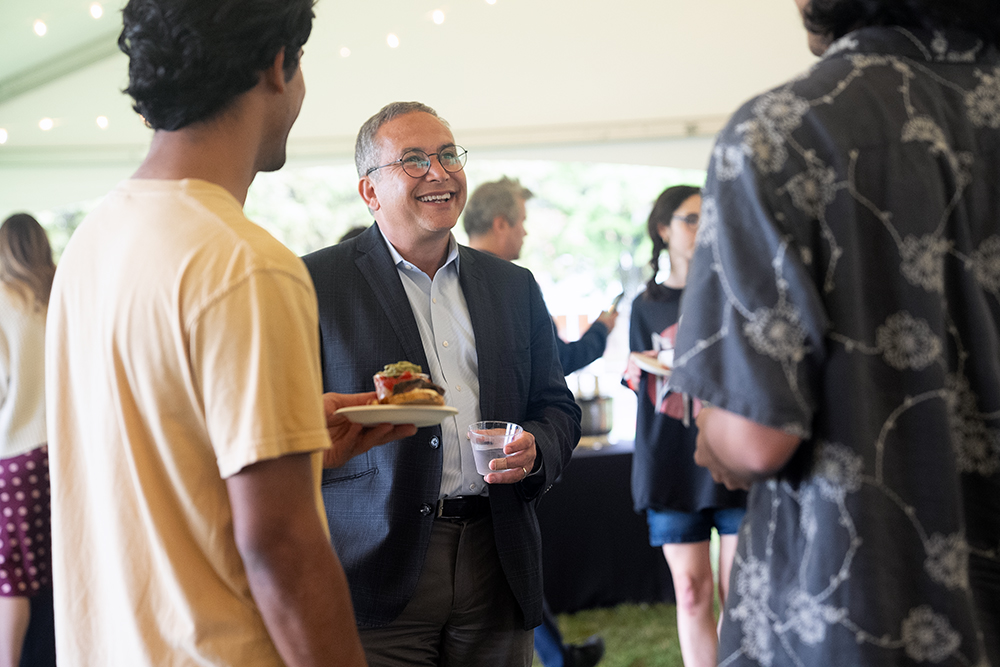 President Adam Weinberg talks with students under the tent at Reese-Shackelford Common. 