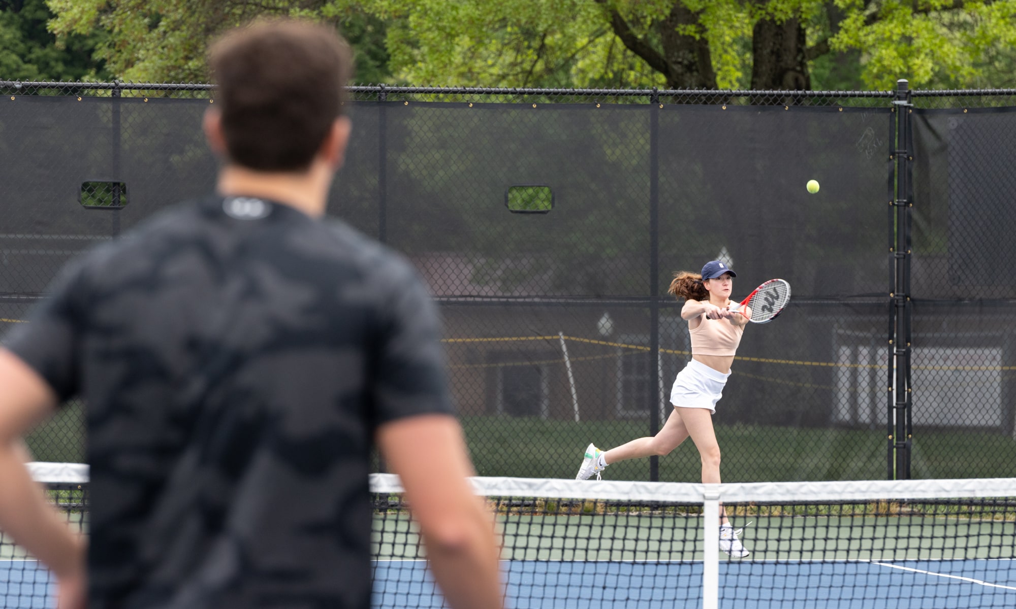 two student play tennis