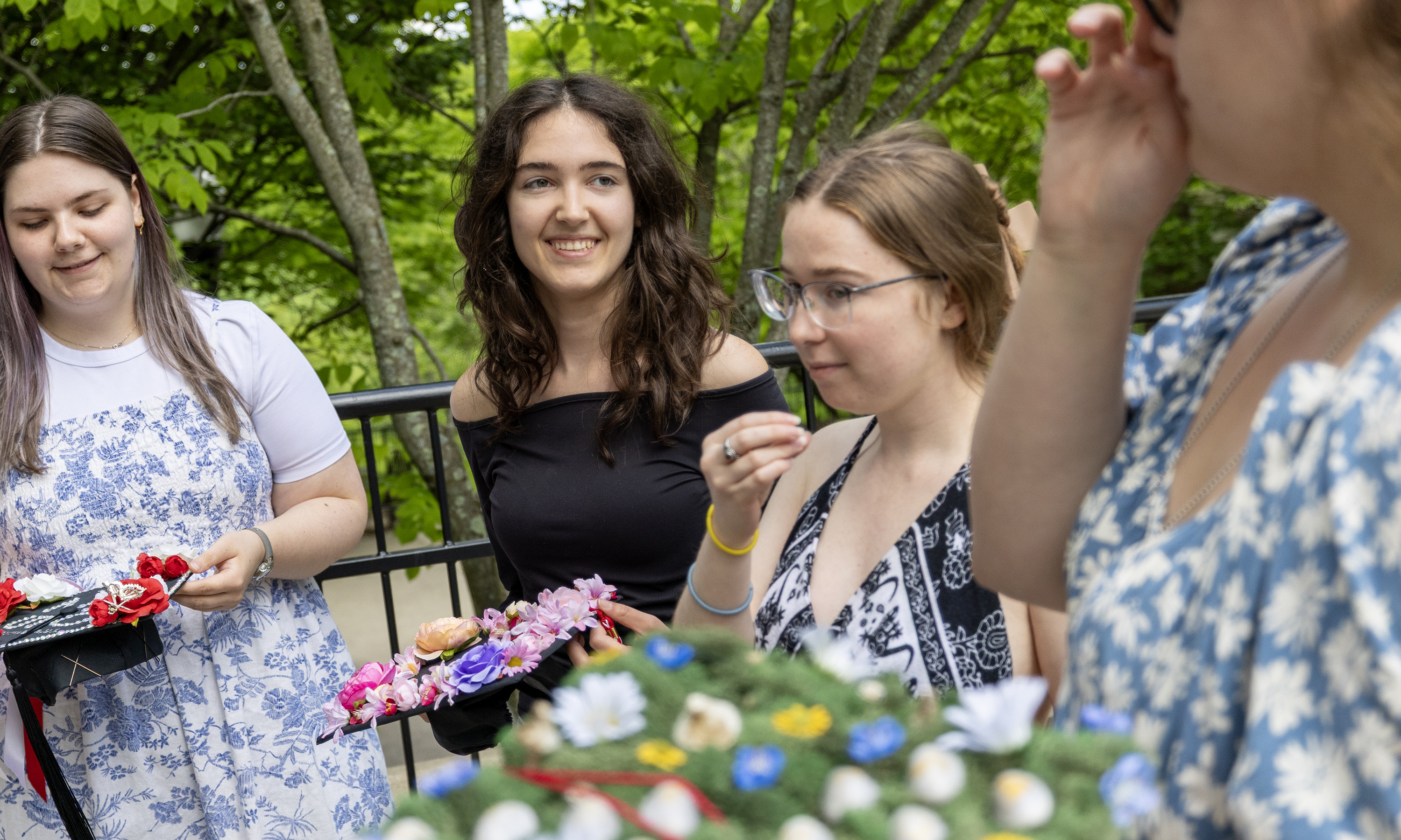 Students display their mortarboards.