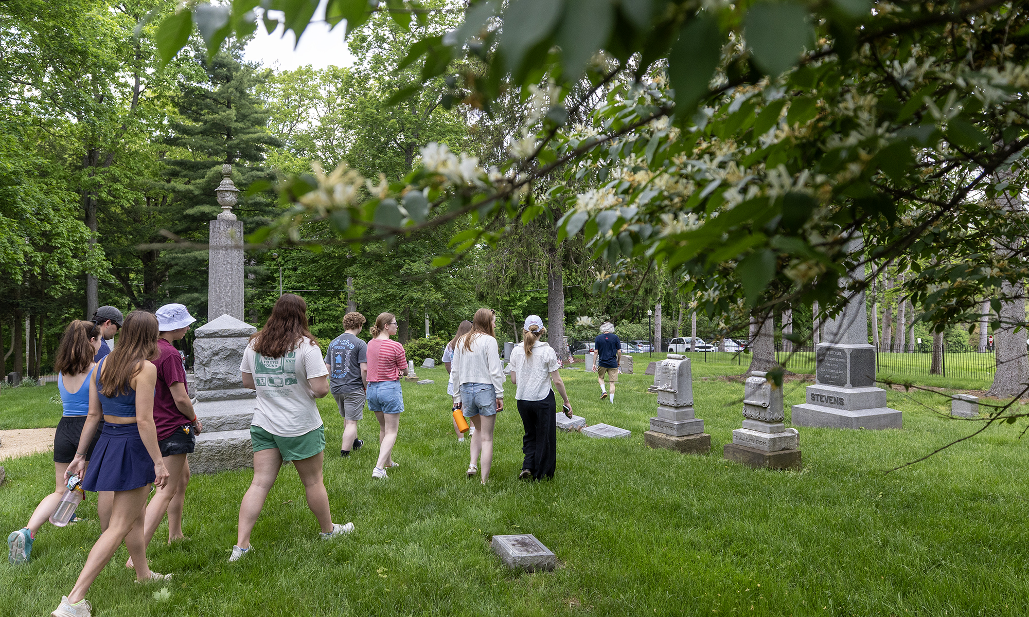 Students walk through College Cemetery