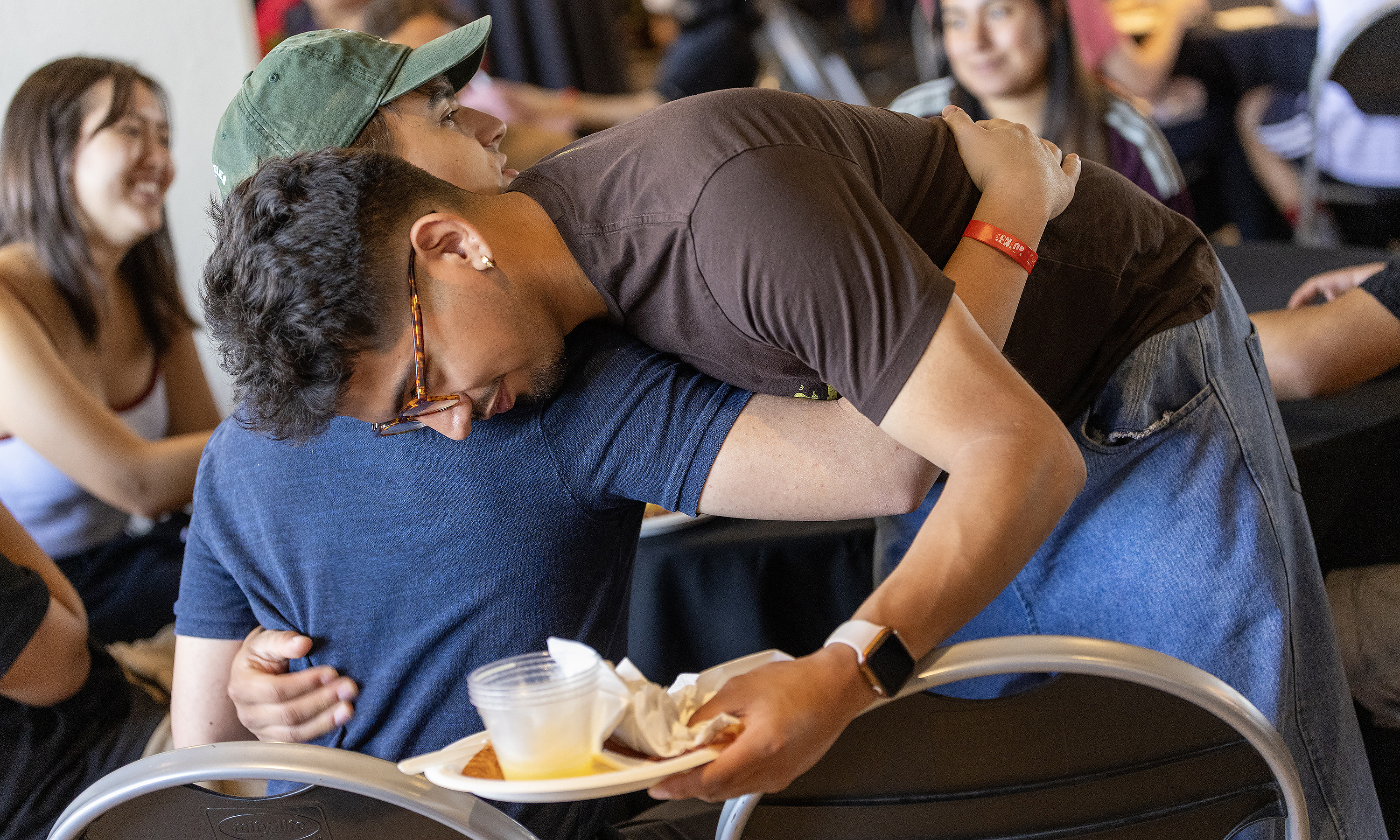 Two students share a hug.