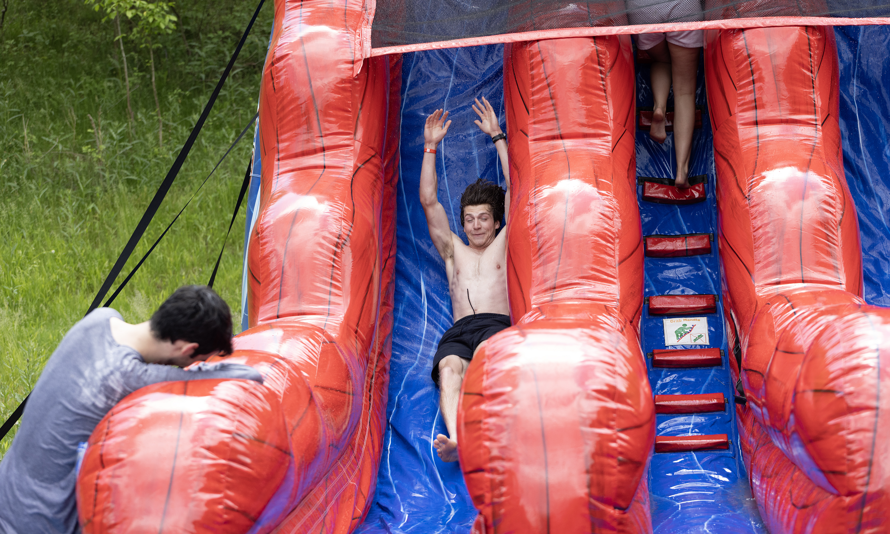 A student slides down a water slide.