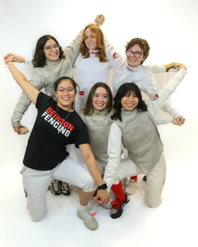 Members of the women's fencing team posing together for a fun group picture.