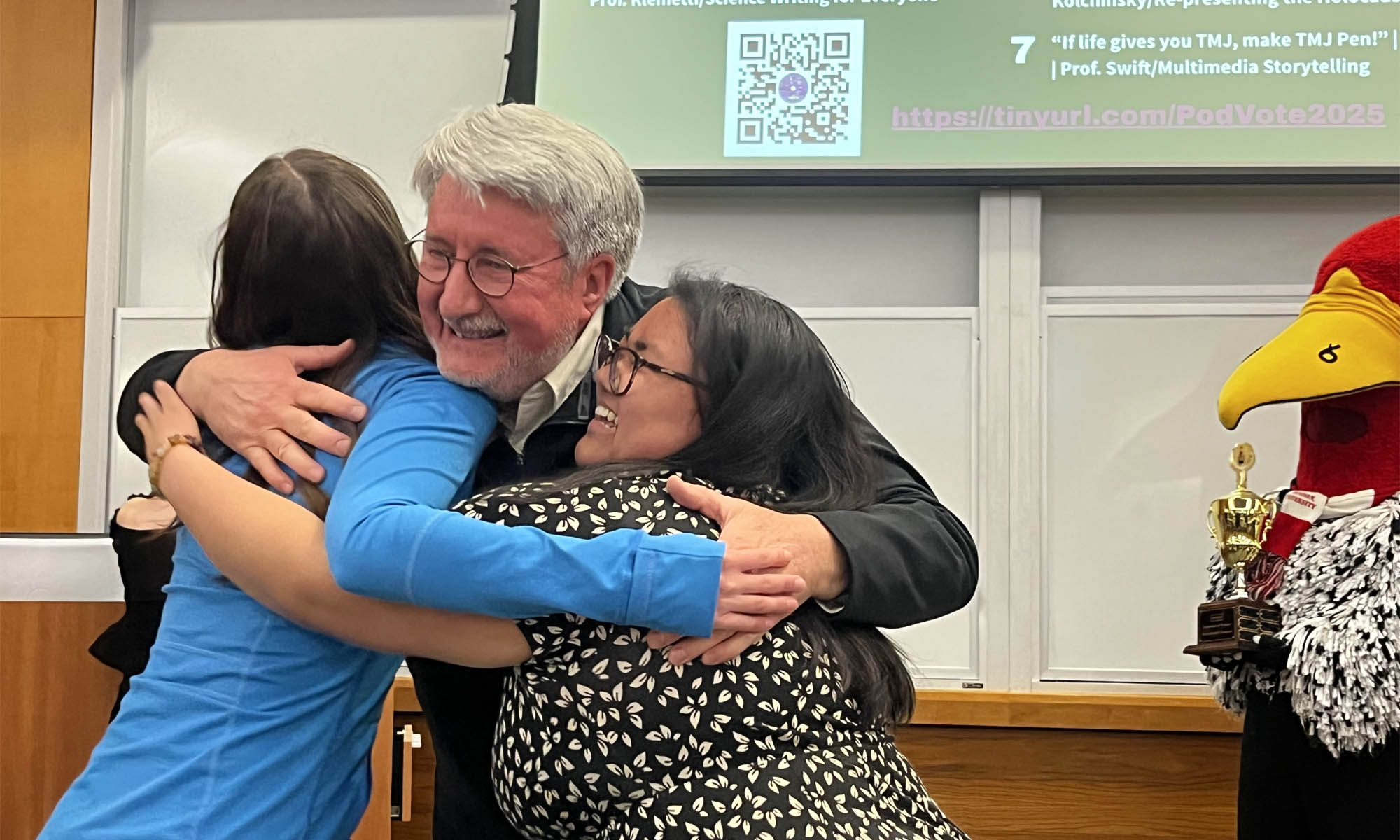 Professor Alan Miller congratulates winners Maddie Luebkert ’27 and Shaye Phillips ’27