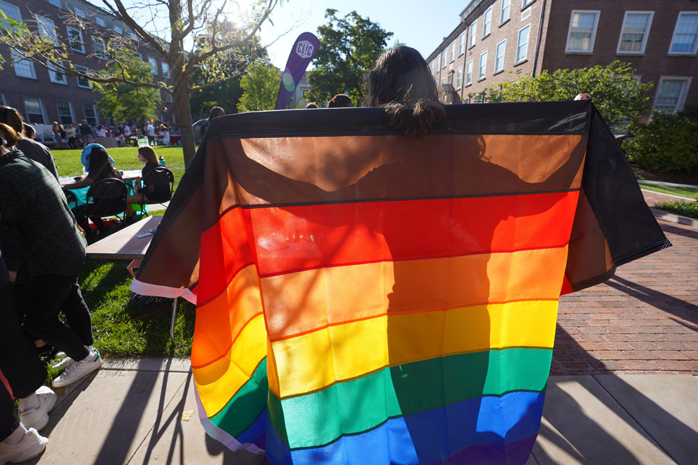 Students holding a rainbow flag.